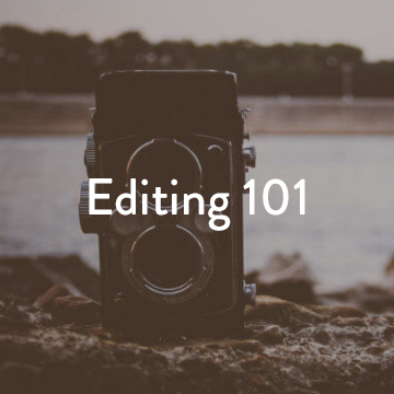 An old video camera is on the ground with a shot of a lake or body of water and woods in the background with text 'Editing 101'